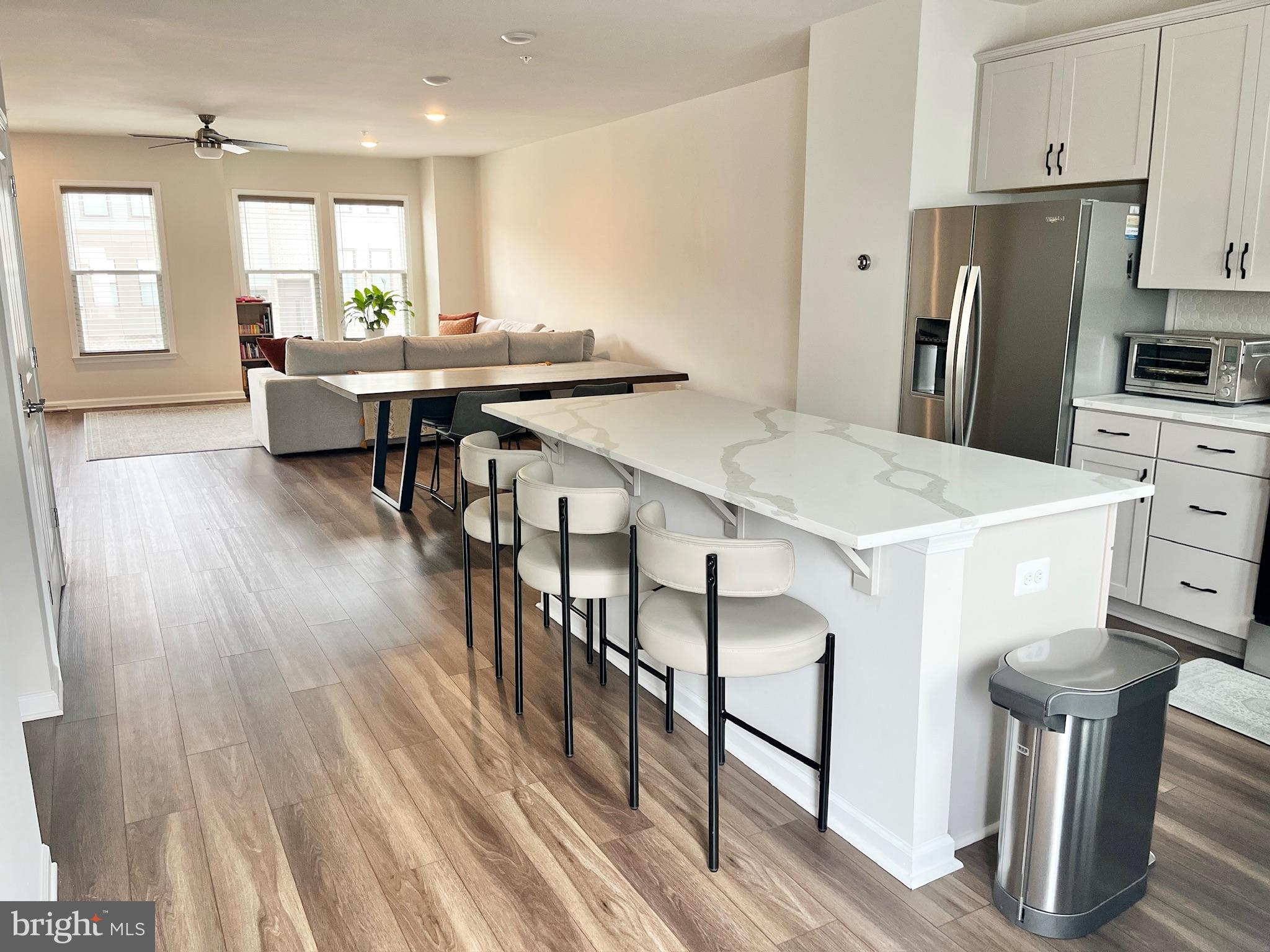 236 Mainstream Drive Laurel, MD 20724 - Photo 5 of 52 a kitchen with stainless steel appliances a dining table chairs refrigerator and sink