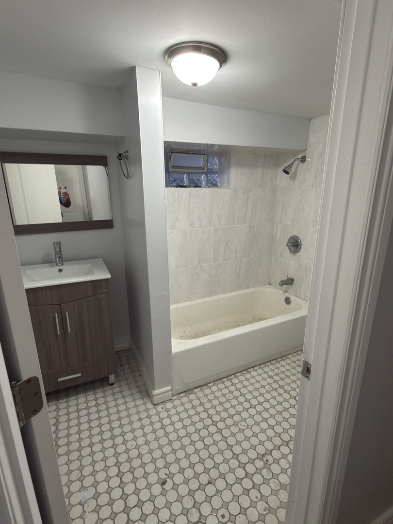 2020 West 69th Place Chicago, IL 60636 - Photo 5 of 12 a bathroom with a bathtub and a shower