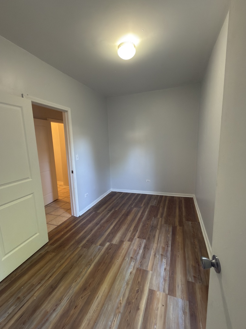 2020 West 69th Place Chicago, IL 60636 - Photo 8 of 12 a view of empty room with wooden floor