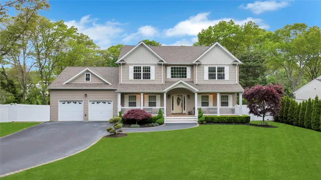 a front view of a house with a garden and plants