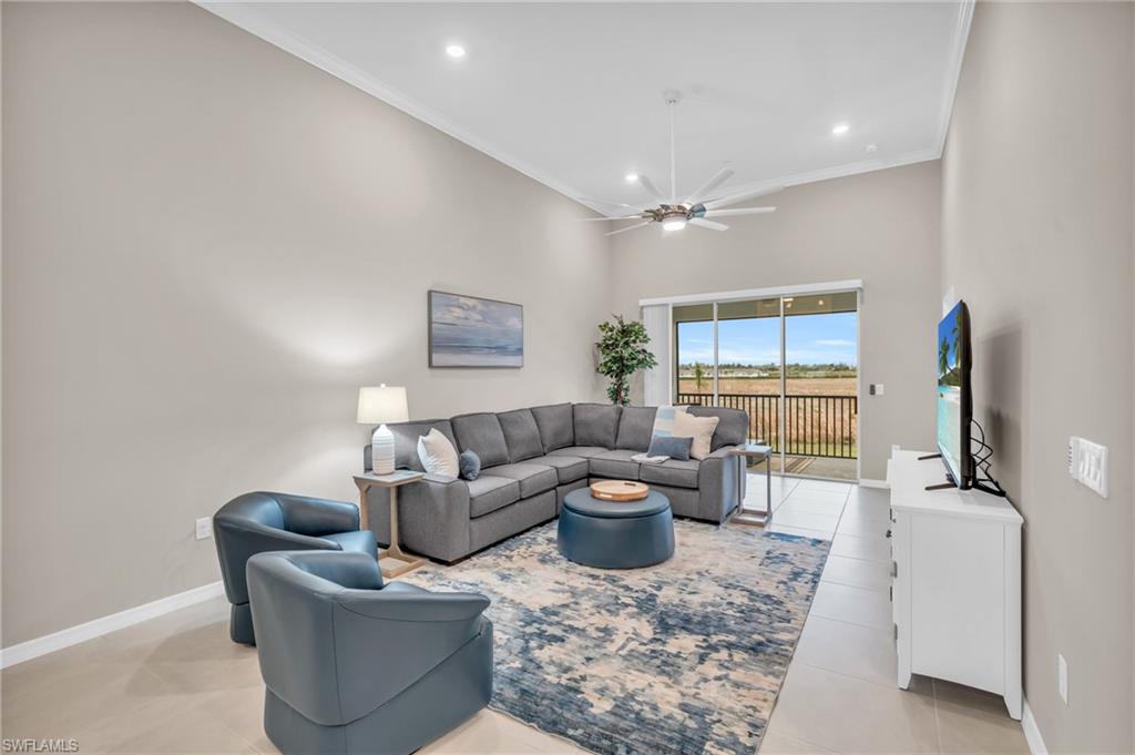 11811 Venetian Lagoon Drive, Unit 202 Fort Myers, FL 33913 - Photo 11 of 50 a living room with furniture a window and a flat screen tv