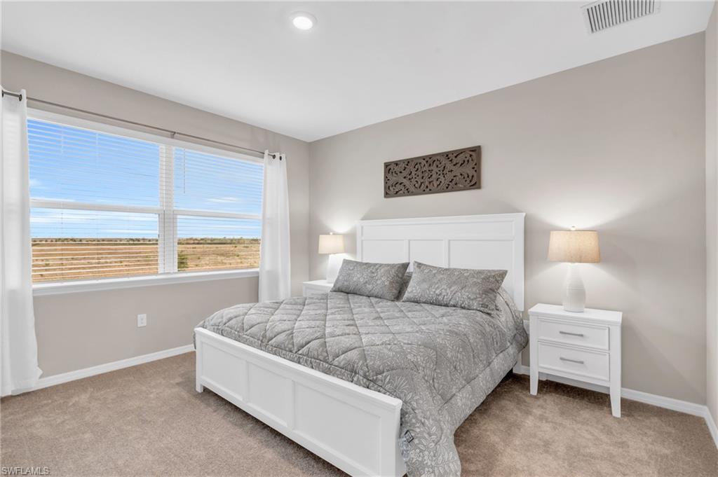 11811 Venetian Lagoon Drive, Unit 202 Fort Myers, FL 33913 - Photo 18 of 50 a bedroom with a bed and a window
