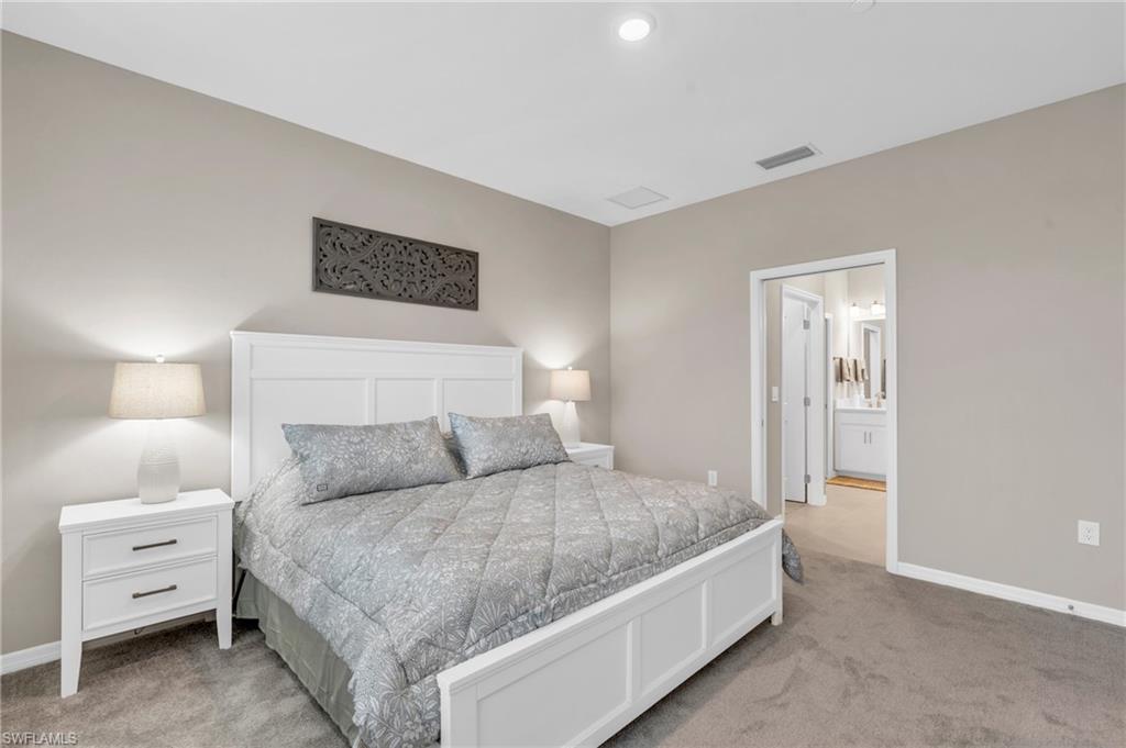11811 Venetian Lagoon Drive, Unit 202 Fort Myers, FL 33913 - Photo 20 of 50 a bedroom with a bed and a night stand