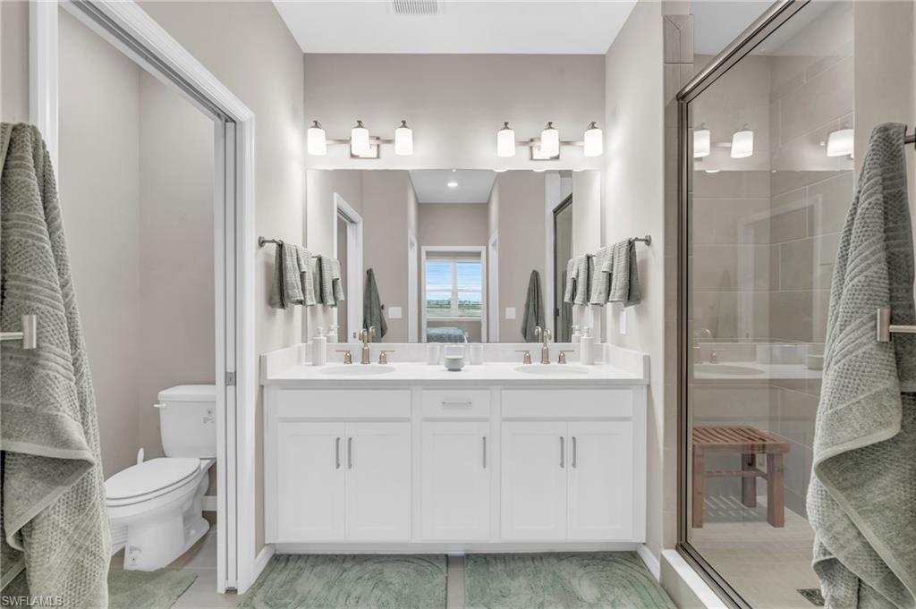 11811 Venetian Lagoon Drive, Unit 202 Fort Myers, FL 33913 - Photo 21 of 50 a bathroom with a sink vanity and a mirror