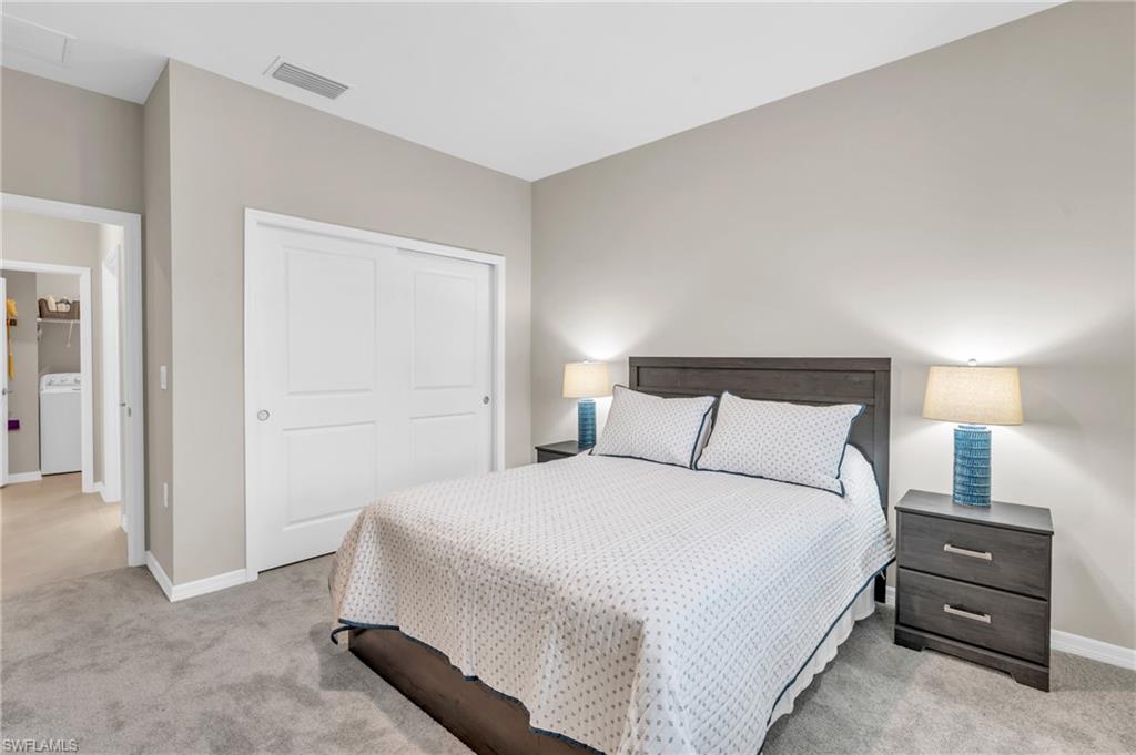 11811 Venetian Lagoon Drive, Unit 202 Fort Myers, FL 33913 - Photo 25 of 50 a bedroom with a bed and a tv