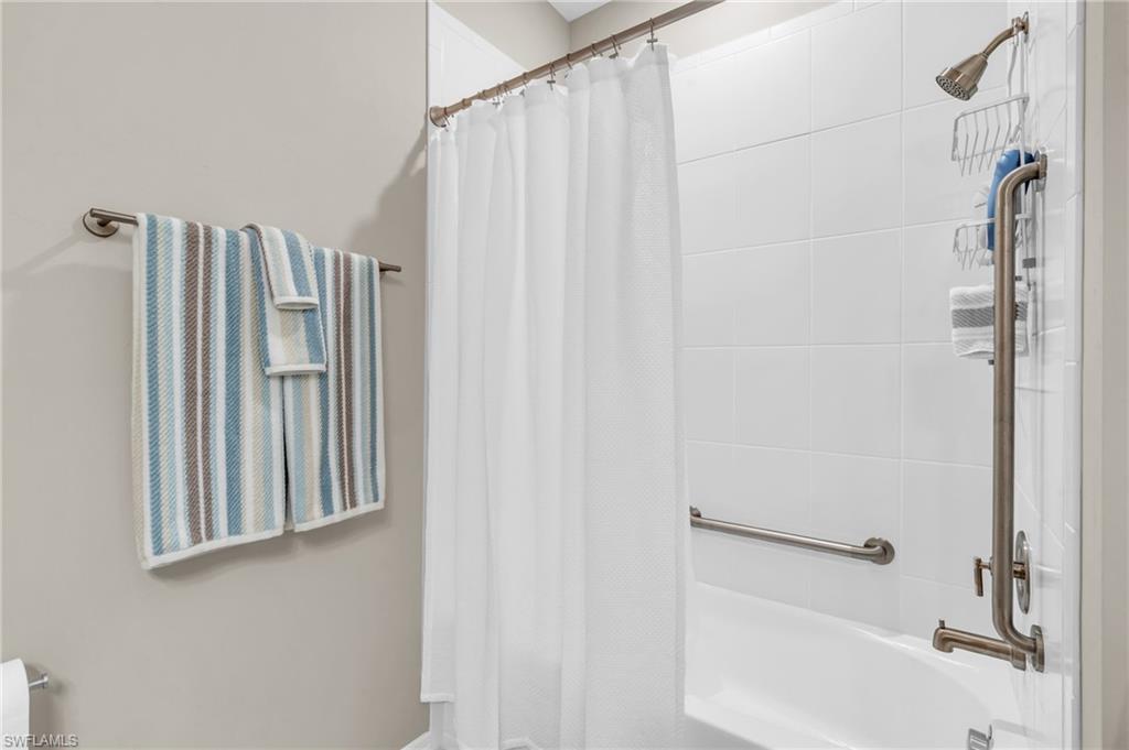 11811 Venetian Lagoon Drive, Unit 202 Fort Myers, FL 33913 - Photo 27 of 50 a bathroom with a shower curtain