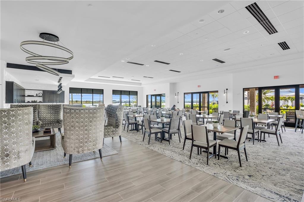 11811 Venetian Lagoon Drive, Unit 202 Fort Myers, FL 33913 - Photo 38 of 50 a view of a dining room with furniture window and wooden floor