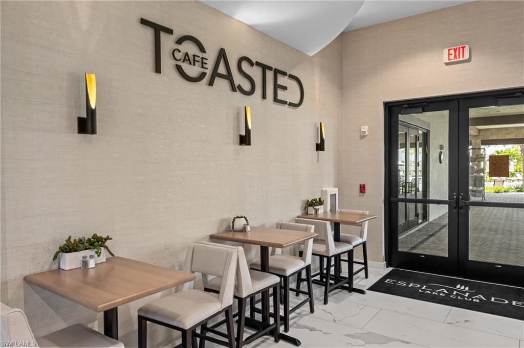 11811 Venetian Lagoon Drive, Unit 202 Fort Myers, FL 33913 - Photo 39 of 50 a view of a dining room with furniture and wooden floor