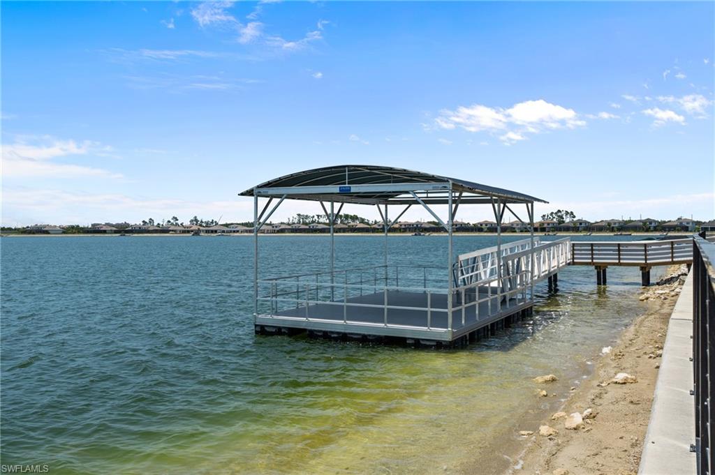 11811 Venetian Lagoon Drive, Unit 202 Fort Myers, FL 33913 - Photo 46 of 50 a view of a lake with a terrace