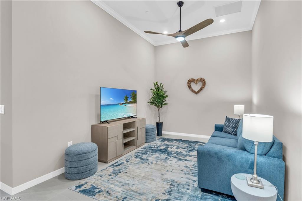 11811 Venetian Lagoon Drive, Unit 202 Fort Myers, FL 33913 - Photo 7 of 50 a living room with furniture and a flat screen tv
