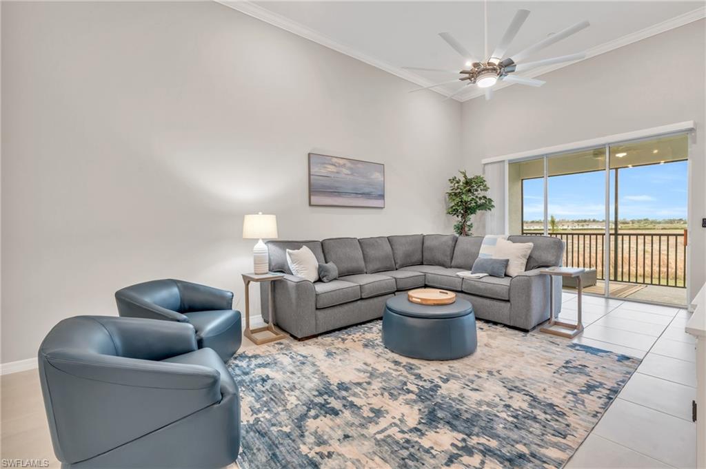 11811 Venetian Lagoon Drive, Unit 202 Fort Myers, FL 33913 - Photo 9 of 50 a living room with furniture and a rug