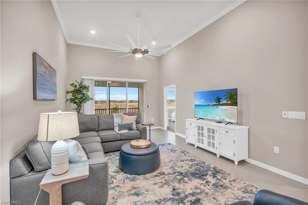 11811 Venetian Lagoon Drive, Unit 202 Fort Myers, FL 33913 - Photo 10 of 50 a living room with furniture a rug and a window