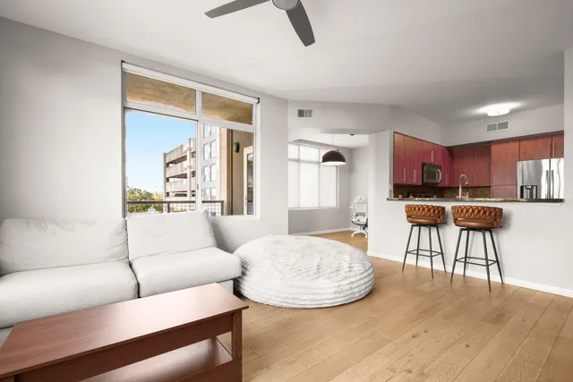 a living room with furniture and a kitchen view