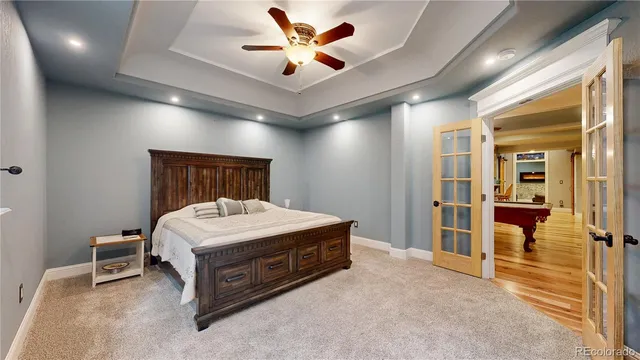 a spacious bedroom with a bed and a ceiling fan