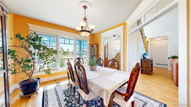 a view of a dining room with furniture window and wooden floor