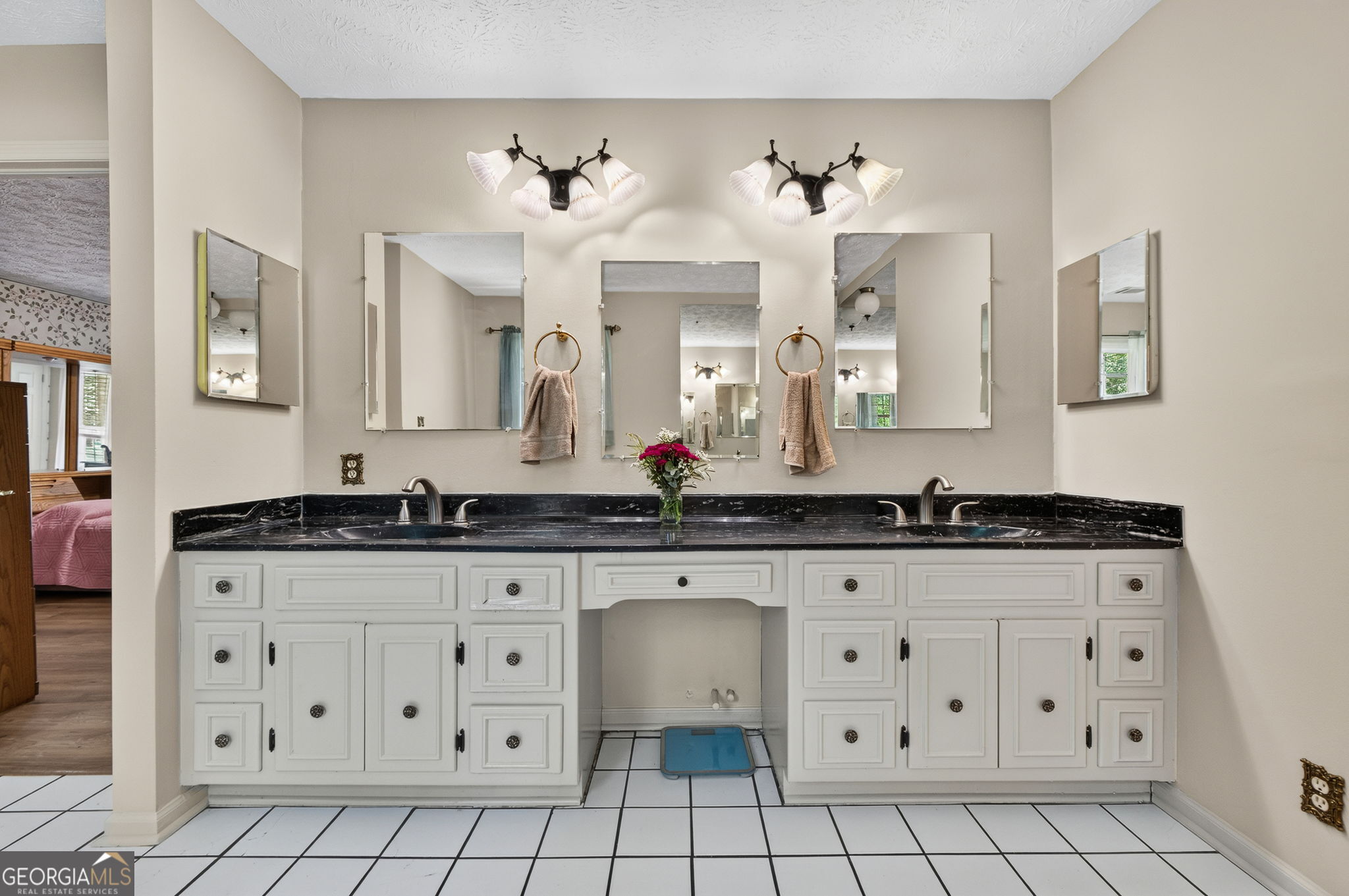 169 Silver Dollar Road Barnesville, GA 30204 - Photo 33 of 66 Large Vanity with his and her sinks, black counter top, white cabinets, built in vanity, tile flooring