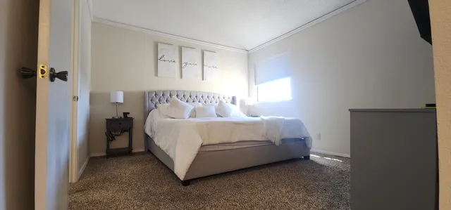 a backyard of a house with table and chairs