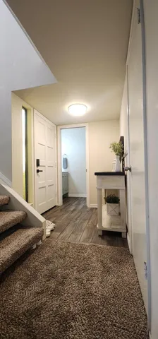 a view of a room with a refrigerator a sink and a mirror