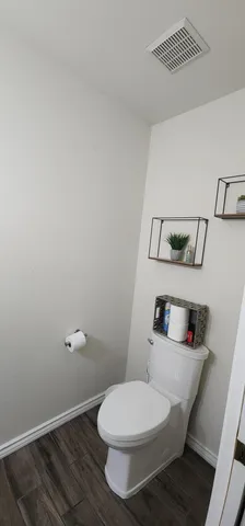 a white toilet sitting next to a bathroom sink