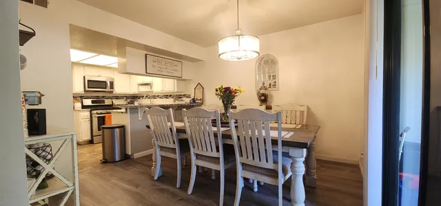 a view of a dining room with furniture window and wooden floor