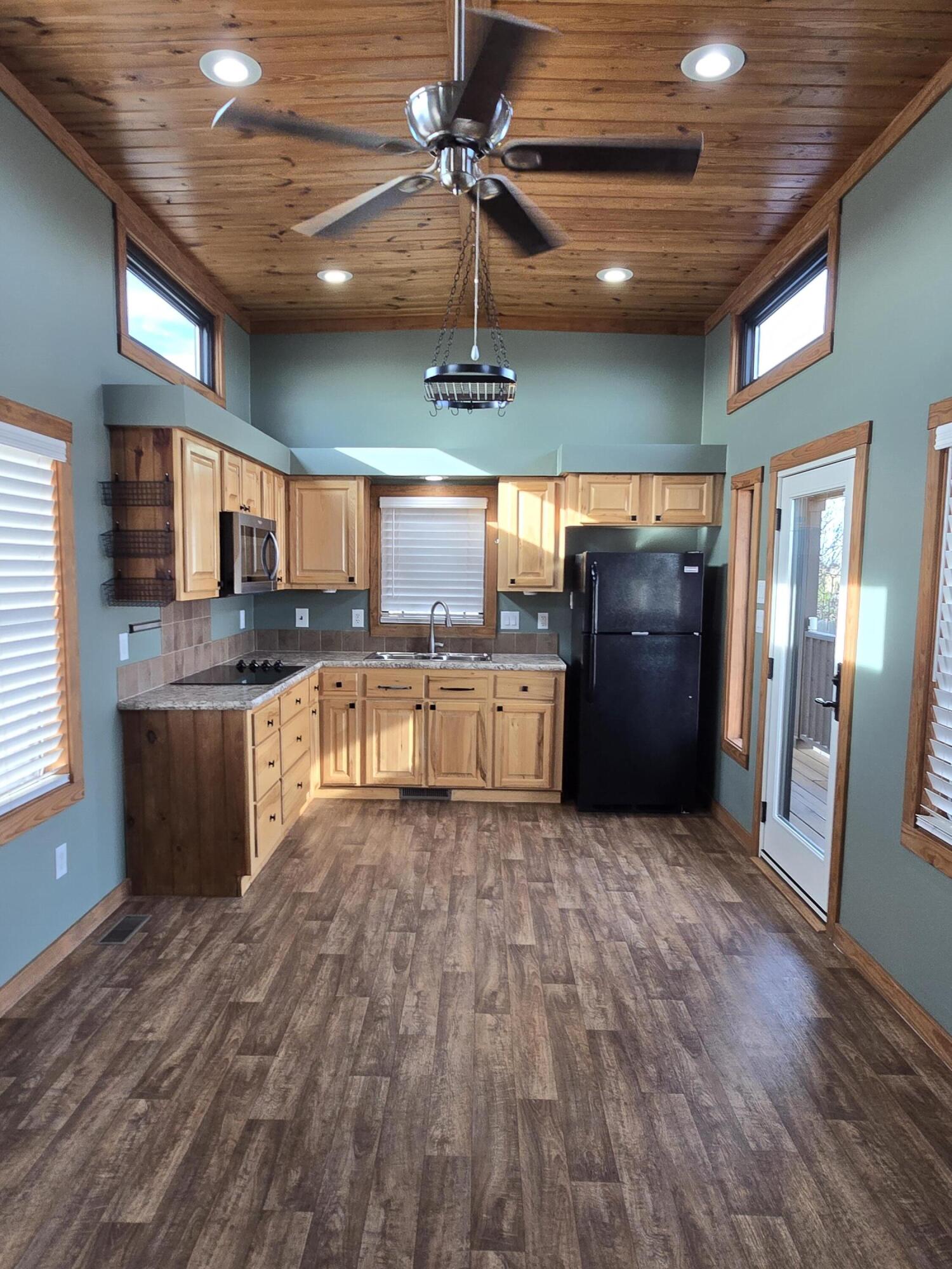 1023 County Road 20 Lamesa, TX 79331 - Photo 2 of 26 a large kitchen with stainless steel appliances granite countertop a stove and a wooden floors