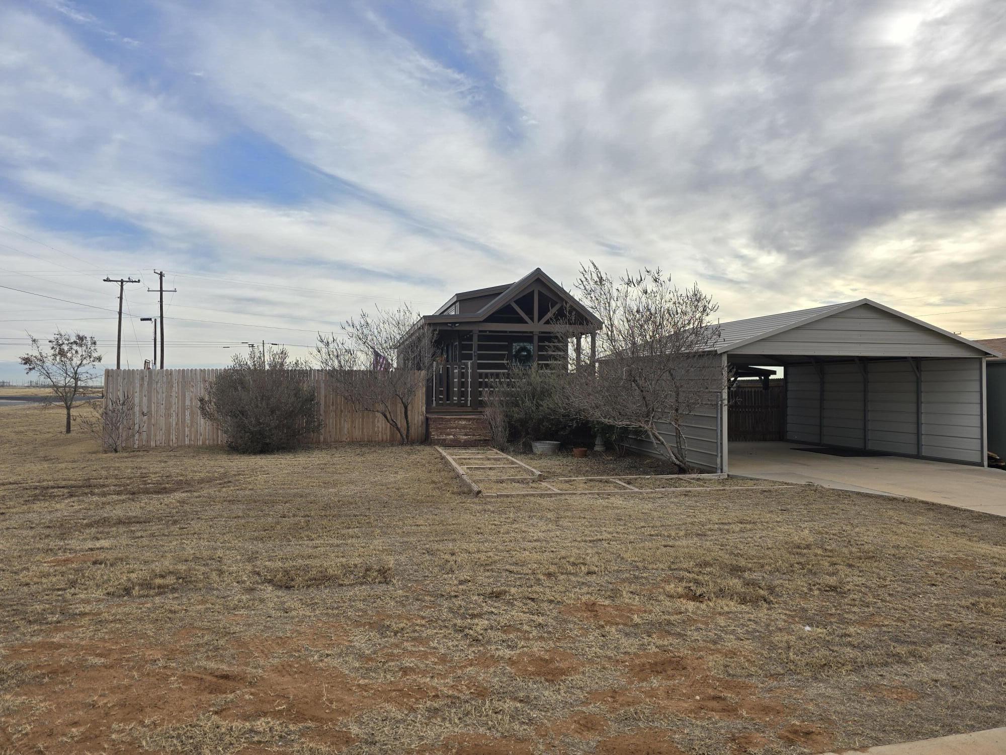 1023 County Road 20 Lamesa, TX 79331 - Photo 21 of 26 a front view of a house with a yard and garage