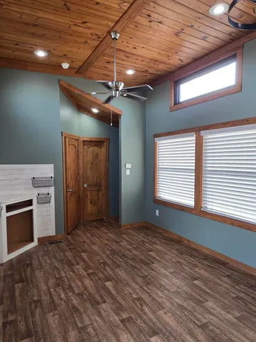 a view of an empty room with a kitchen