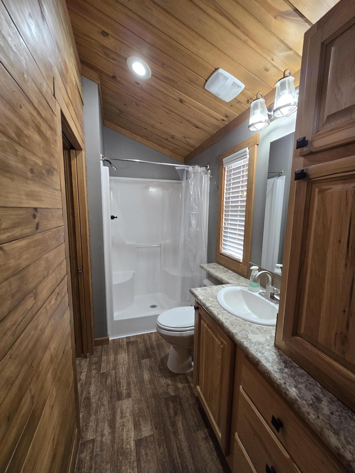 1023 County Road 20 Lamesa, TX 79331 - Photo 6 of 26 a bathroom with a granite countertop sink toilet and shower