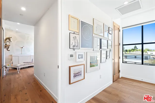 wooden floor with white walls and windows