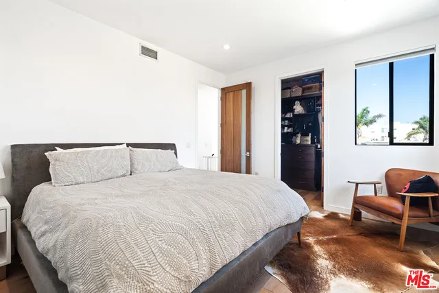 a bedroom with bed and chair