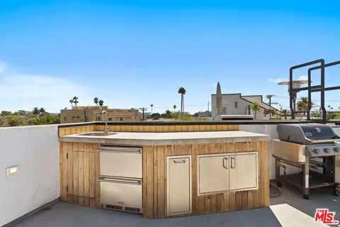 a bathroom with a granite countertop sink and a toilet