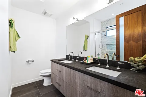 a spacious bathroom with a granite countertop sink a mirror and a