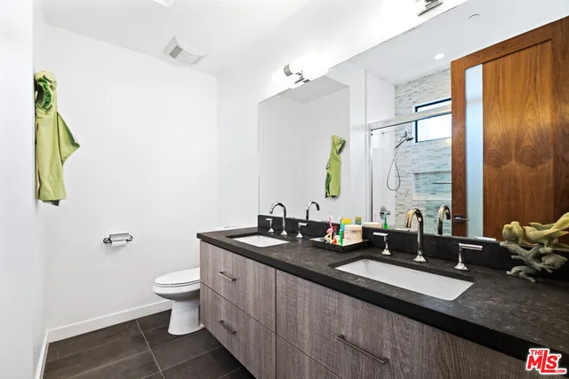 a spacious bathroom with a granite countertop sink a mirror and a