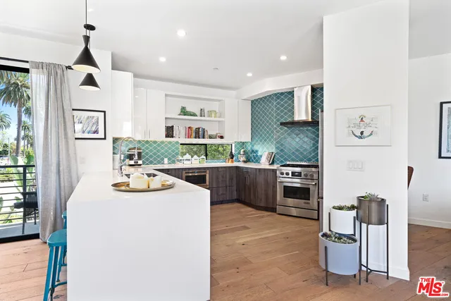 a kitchen with stainless steel appliances kitchen island granite countertop a sink and cabinets
