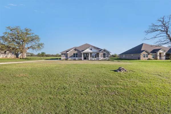a view of an house with a yard and front view of a house