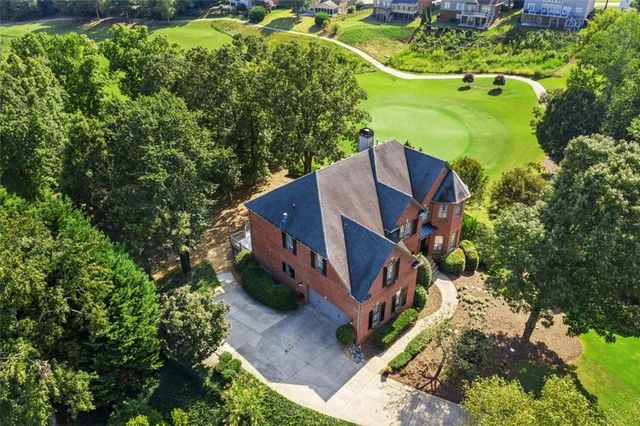 a view of a house with a yard and sitting area
