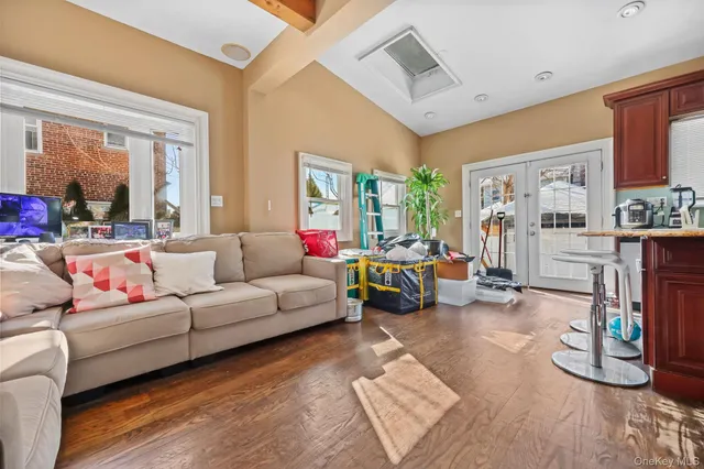a living room with furniture a flat screen tv and a large window