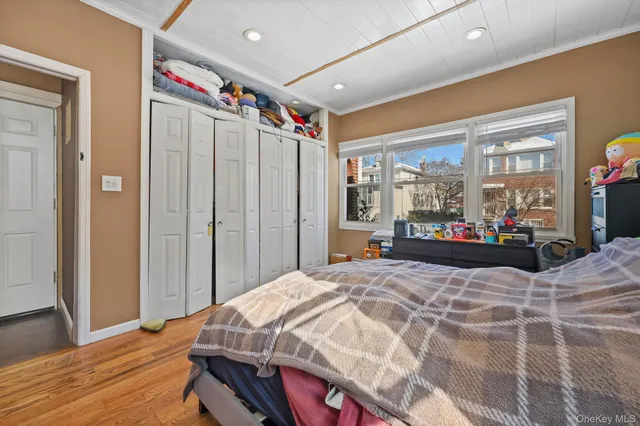 a bed room with a bed couch and a window