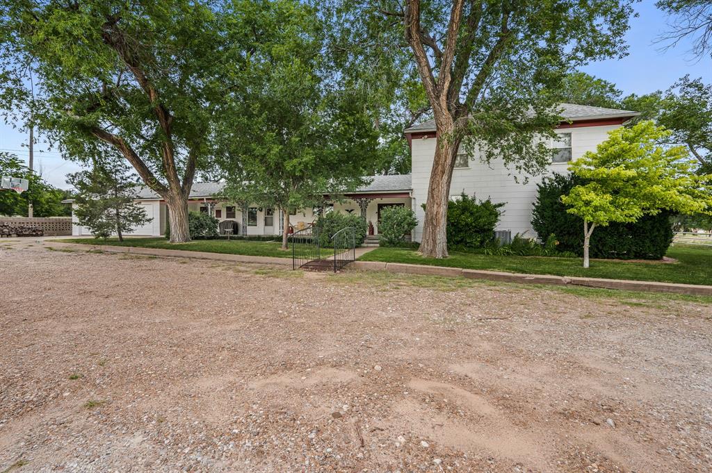 1204 East Cheyenne Avenue Canadian, TX 79014 - Photo 2 of 39 a view of a house with a big yard and large trees