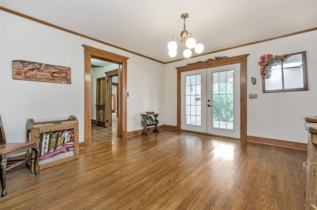 1204 East Cheyenne Avenue Canadian, TX 79014 - Photo 23 of 39 a view of a room with wooden floor chandelier and windows