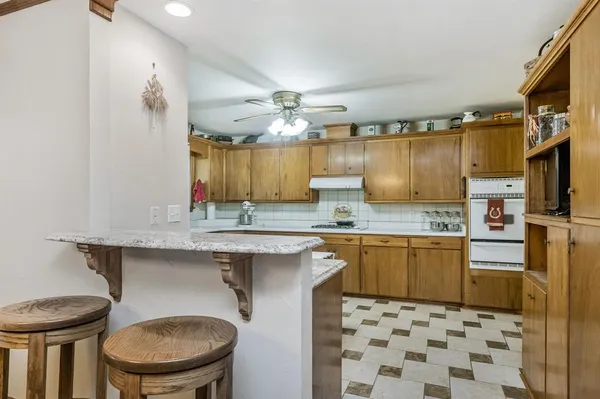 a kitchen with a sink a stove a refrigerator and cabinets