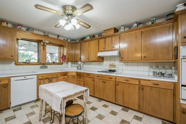 a kitchen with a sink stove and cabinets