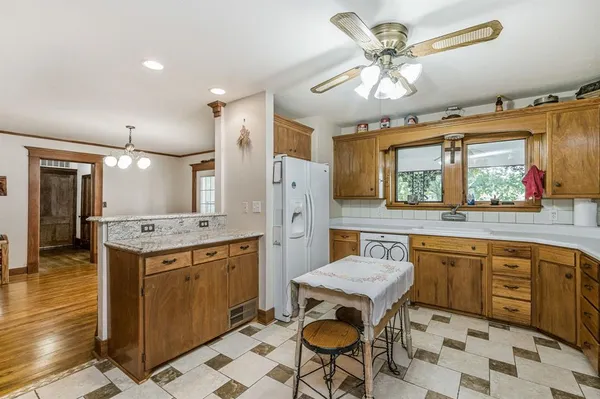 a kitchen with a stove a sink a dining table and chairs