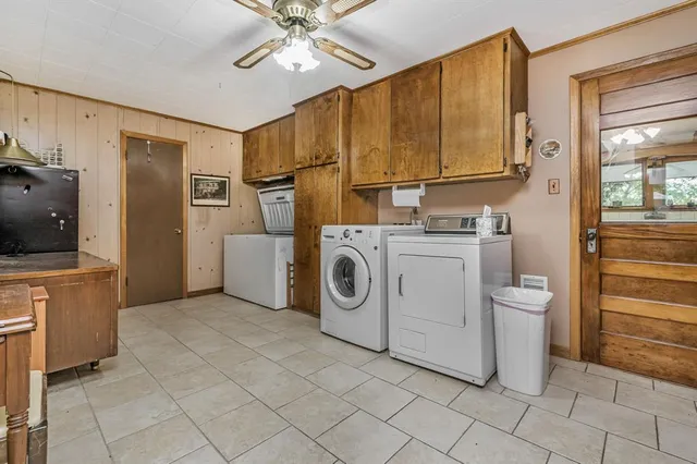 a utility room with cabinets dryer and washer