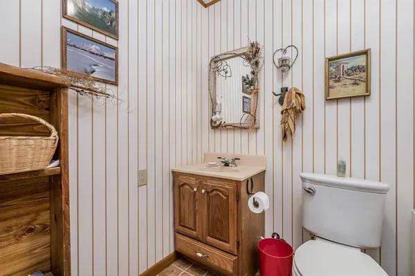 a bathroom with a toilet a sink and a shower curtain