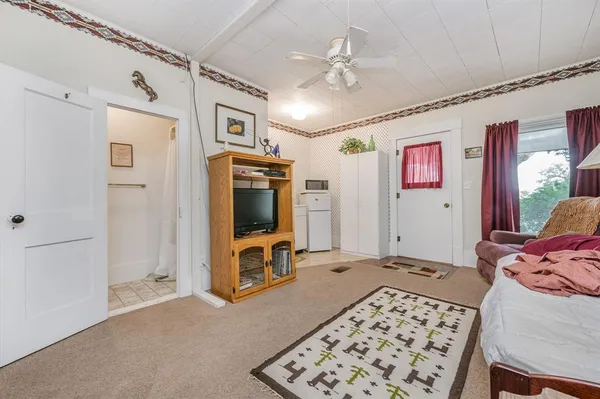 a bedroom with furniture and a flat screen tv