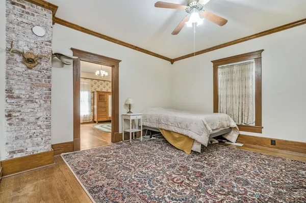 a bedroom with a bed and a chandelier