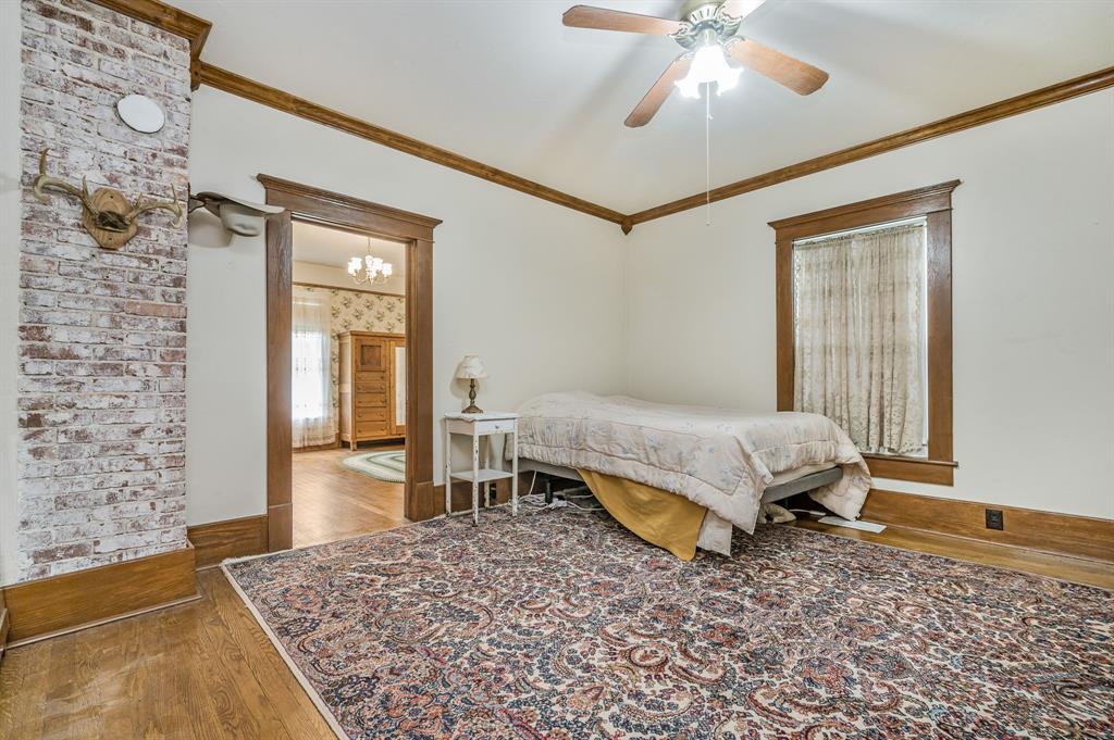 1204 East Cheyenne Avenue Canadian, TX 79014 - Photo 37 of 39 a bedroom with a bed and a chandelier