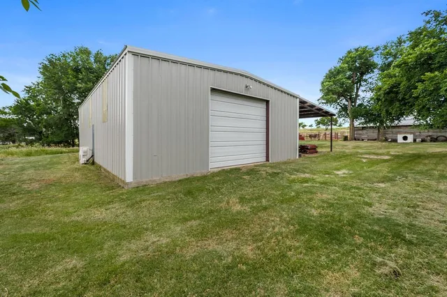 a view of a backyard with large trees