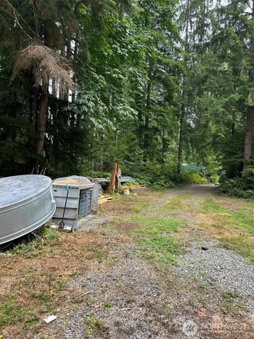 a white bench sitting in the middle of a yard
